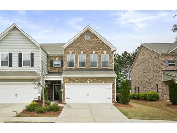 Charming brick two-story home featuring an attached two-car garage and well-maintained landscaping at 2623 Bloom Cir, Tucker, GA 30084