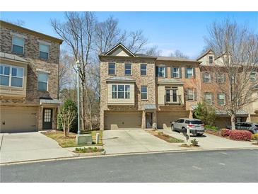 Attractive townhome complex features brick facade, individual driveways and garages at 2782 Laurel Valley Trl, Buford, GA 30519