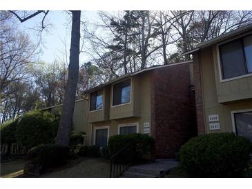 Inviting exterior view of townhomes with well-maintained landscaping and classic brick accents at 2211 Surrey Se Ct, Marietta, GA 30067