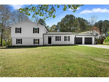 Charming two-story home with a well-maintained front yard and a two car garage at 3351 Grand Central Dr, Snellville, GA 30078
