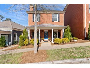 Charming two-story brick home with covered front porch and well-manicured landscaping at 4121 N Swann St, Covington, GA 30014