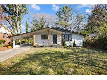 Charming home with a covered parking area and a well-maintained front yard at 1275 Calhoun Ave, Atlanta, GA 30344
