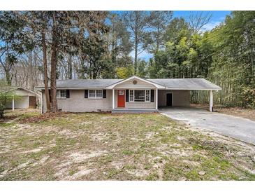Charming one-story home with a cozy carport and red front door entrance at 6510 Hazel St, Lithia Springs, GA 30122