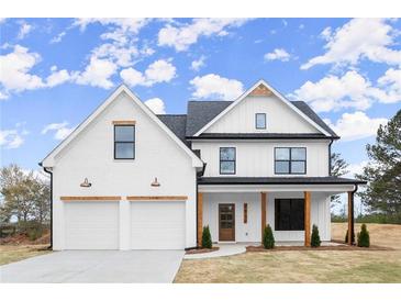 Charming two-story home with white siding, black trim, and inviting front porch at 5010 Hyde Way, Cumming, GA 30040