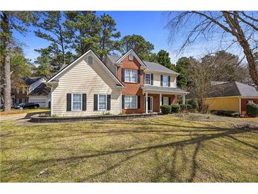 Charming two-story home with a well-manicured lawn and beautiful landscaping at 1151 Adah Ln, Lawrenceville, GA 30043