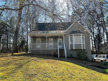 Charming home with a covered front porch, bay window, and well-maintained lawn at 1924 Sidneys Cv, Lawrenceville, GA 30043