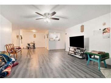 Inviting living room featuring gray laminate flooring and a ceiling fan at 417 Ridge Creek Dr, Clarkston, GA 30021