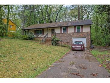Traditional home featuring brick accents, attached garage, and an inviting front yard at 1513 Spruce Ridge Way, Stone Mountain, GA 30083