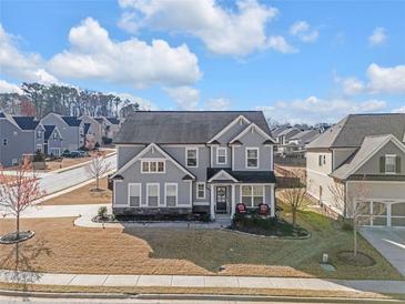 Beautiful two-story home with manicured lawn, lovely landscape and charming front porch at 2650 Longacre Park Way, Lawrenceville, GA 30044