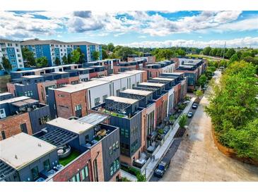 Contemporary townhome community featuring brick and modern siding, rooftop terraces, and lush landscaping at 1239 Chelsea Nw Cir, Atlanta, GA 30318