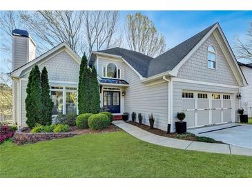 Charming two-story home featuring a landscaped yard, attached two-car garage and neutral color palette at 7115 Harbour Lndg, Alpharetta, GA 30005