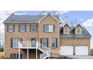 Charming brick home featuring a two-car garage and inviting stairway entry at 3655 Autumn Ridge Pkwy, Marietta, GA 30066