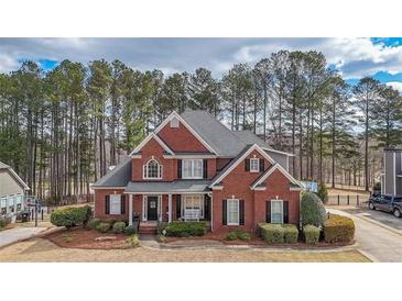 Charming two-story brick home with a well-manicured lawn and mature trees providing a private, serene setting at 151 Creek Bank Dr, Acworth, GA 30101
