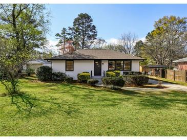 Charming single-story home with a well-maintained lawn and mature landscaping, perfect for suburban living at 863 Birch St, Forest Park, GA 30297