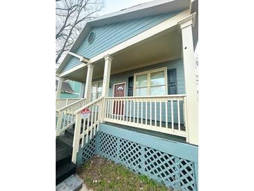 Inviting home featuring a covered porch, wood trim and a cozy aesthetic at 971 Martin Se St, Atlanta, GA 30315