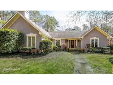 Charming single-story home with lush landscaping and a welcoming front entrance at 4751 Bill Cheek Rd, Auburn, GA 30011