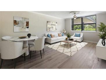Bright living room featuring modern decor, neutral tones, and hardwood floors, perfect for relaxation and entertaining guests at 2965 Pharr Court South Nw # 102, Atlanta, GA 30305