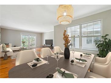 Inviting dining area with modern lighting and an open layout to the living room at 1150 Collier Nw Rd # J11, Atlanta, GA 30318