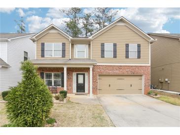 Charming two-story home featuring a brick-accented facade, neutral siding, and a well-manicured front yard at 2248 Newbury Oaks Dr, Lawrenceville, GA 30044