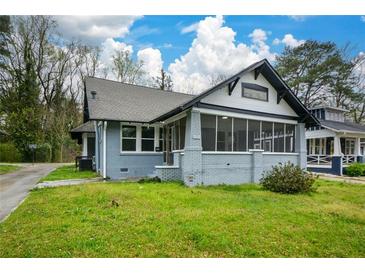 Charming single-story home featuring a screened-in front porch and a freshly painted exterior at 984 Cascade Sw Rd, Atlanta, GA 30311