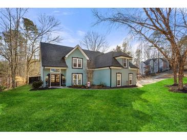Charming two-story home with a well-manicured lawn and inviting curb appeal at 1206 Red Fox Cir, Woodstock, GA 30188