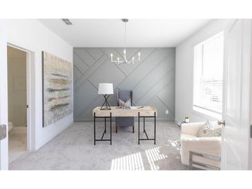Bright home office featuring stylish accent wall, modern desk, and natural light from a large window at 510 Healy Dr # 71, Cumming, GA 30040