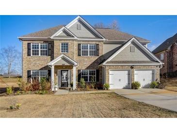 Charming two-story home with brick facade, attached two-car garage, and well-manicured lawn at 104 Camilla Dr, Carrollton, GA 30116