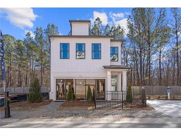 Charming two-story home with white siding, black trim, and a well-manicured front yard at 733 Stickley Oak Way, Woodstock, GA 30189