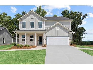 Beautiful two-story home with a welcoming front porch and manicured lawn at 808 Tupelo Way, Villa Rica, GA 30180