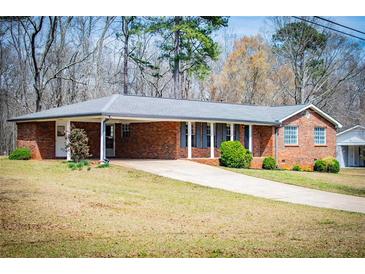 Charming brick home with well-maintained lawn and inviting carport at 6355 Valhalla Dr, Douglasville, GA 30135