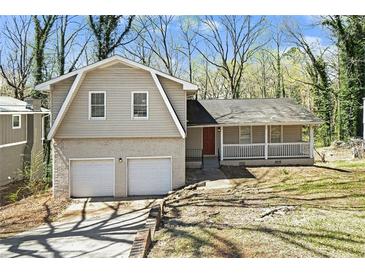 Charming home featuring a two-car garage, brick accents, and a welcoming front porch at 2339 Chevy Chase Ln, Decatur, GA 30032