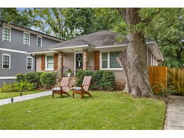 Charming home featuring a stone porch, shuttered windows, landscaped yard, and inviting front sitting area at 746 Amsterdam Ave, Atlanta, GA 30306