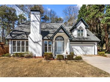 Charming home featuring a white exterior, well-manicured front yard and attached two-car garage at 290 Leigh Kay Dr, Lawrenceville, GA 30046
