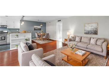 Open-concept living area featuring hardwood floors, modern decor, and comfortable seating at 401 Woodcliff Dr, Atlanta, GA 30350