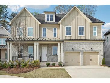Charming two-story home featuring a two-car garage, inviting front porch, and neutral color scheme at 278 Tillman Pass, Woodstock, GA 30188