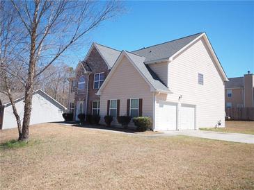 Charming two-story home featuring a two-car garage, brick accents, and well-maintained landscaping at 7267 Appaloosa Cv, Fairburn, GA 30213