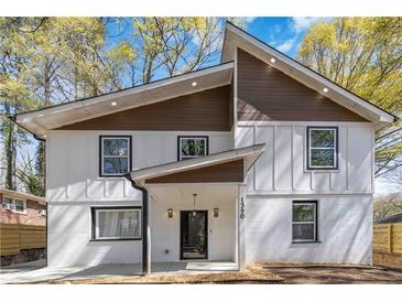 Charming two-story home featuring modern siding, black-framed windows, and a welcoming front porch at 1350 Elizabeth Sw Ave, Atlanta, GA 30310