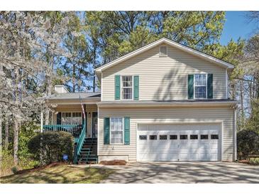 Inviting two-story home with a two car garage and a charming covered porch, perfect for a Gathering at 656 New Hope Rd, Lawrenceville, GA 30046