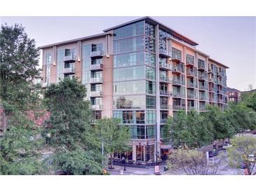 Modern condo building featuring balconies, large windows, and street-level shops at 905 Juniper Ne St # 110, Atlanta, GA 30309