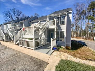 Charming townhouse with beautiful white trim, painted siding and wood stairs at 3705 Tradewinds Dr, Cumming, GA 30041