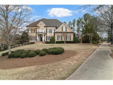 Elegant two-story home featuring a balcony, manicured lawn, and welcoming entrance at 19 Troup Ct, Acworth, GA 30101