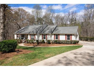 Charming single-story home with white siding, red shutters, and manicured landscaping at 4150 E East Chapel Hill Rd, Douglasville, GA 30135