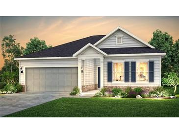 Charming one-story home with a two-car garage, manicured lawn, and beautiful landscaping at 2098 Amaryllis Dr, Grayson, GA 30017