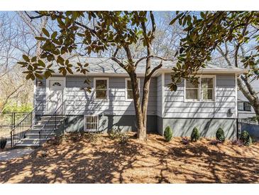 Charming exterior of gray home with landscaped front yard and steps leading to front door at 2126 Jernigan Se Dr, Atlanta, GA 30315