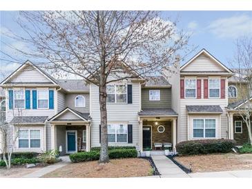 Charming townhomes featuring manicured landscaping, covered entrances, and diverse architectural details at 2449 Suwanee Pointe Dr, Lawrenceville, GA 30043