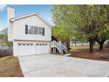 Charming home featuring a two-car garage and a cozy front porch with stairs leading to the entrance at 2172 Creekview Trl, Decatur, GA 30035