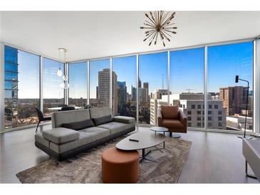 Bright living room featuring floor to ceiling windows with expansive city views, modern furniture, and stylish lighting at 1080 Peachtree Ne St # 1610, Atlanta, GA 30309