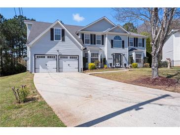 Charming two-story home with a well-manicured lawn, two car garage, and inviting entrance at 1979 Resting Creek Dr, Decatur, GA 30035