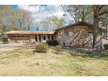 Charming single-story home featuring a stone and brick facade and attached two-car garage at 1254 Renee Dr, Decatur, GA 30035