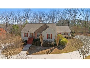 Charming single-Gathering home featuring a stone accent wall and beautifully landscaped front yard at 4740 Union Hill Rd, Canton, GA 30115